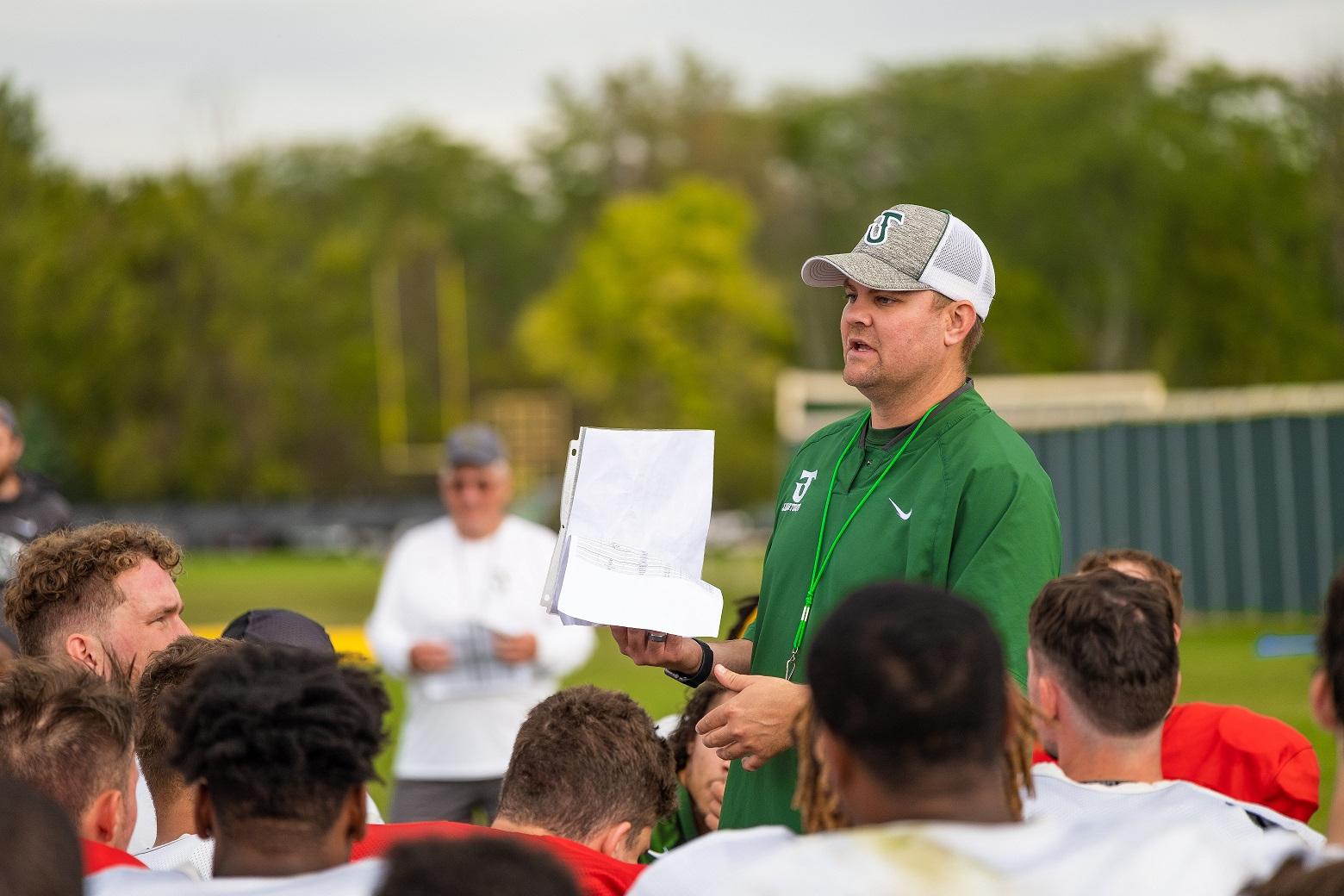 football coach talking to players